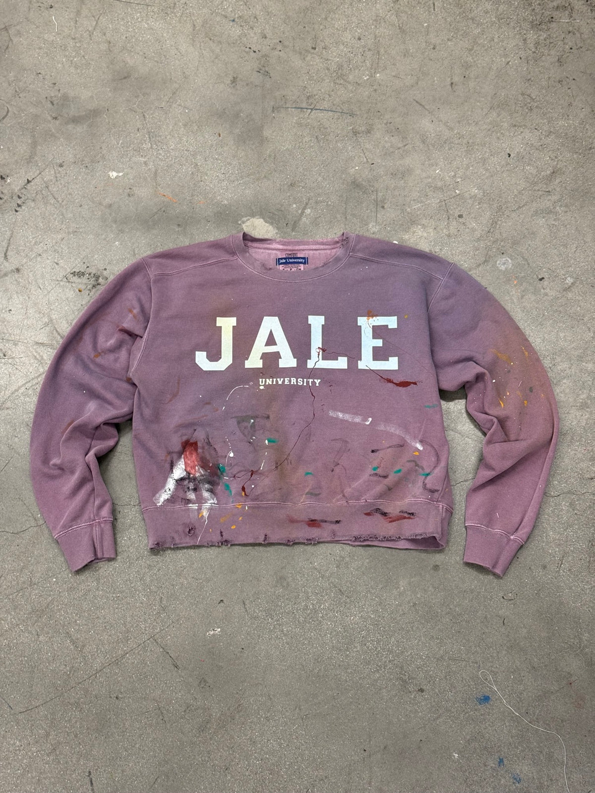 paint-splattered JALE University sweatshirt flat lay